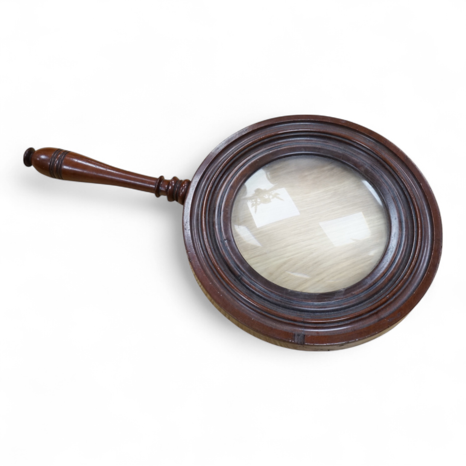 A large oversized 19th century fruitwood magnifying glass, 50cm in length
